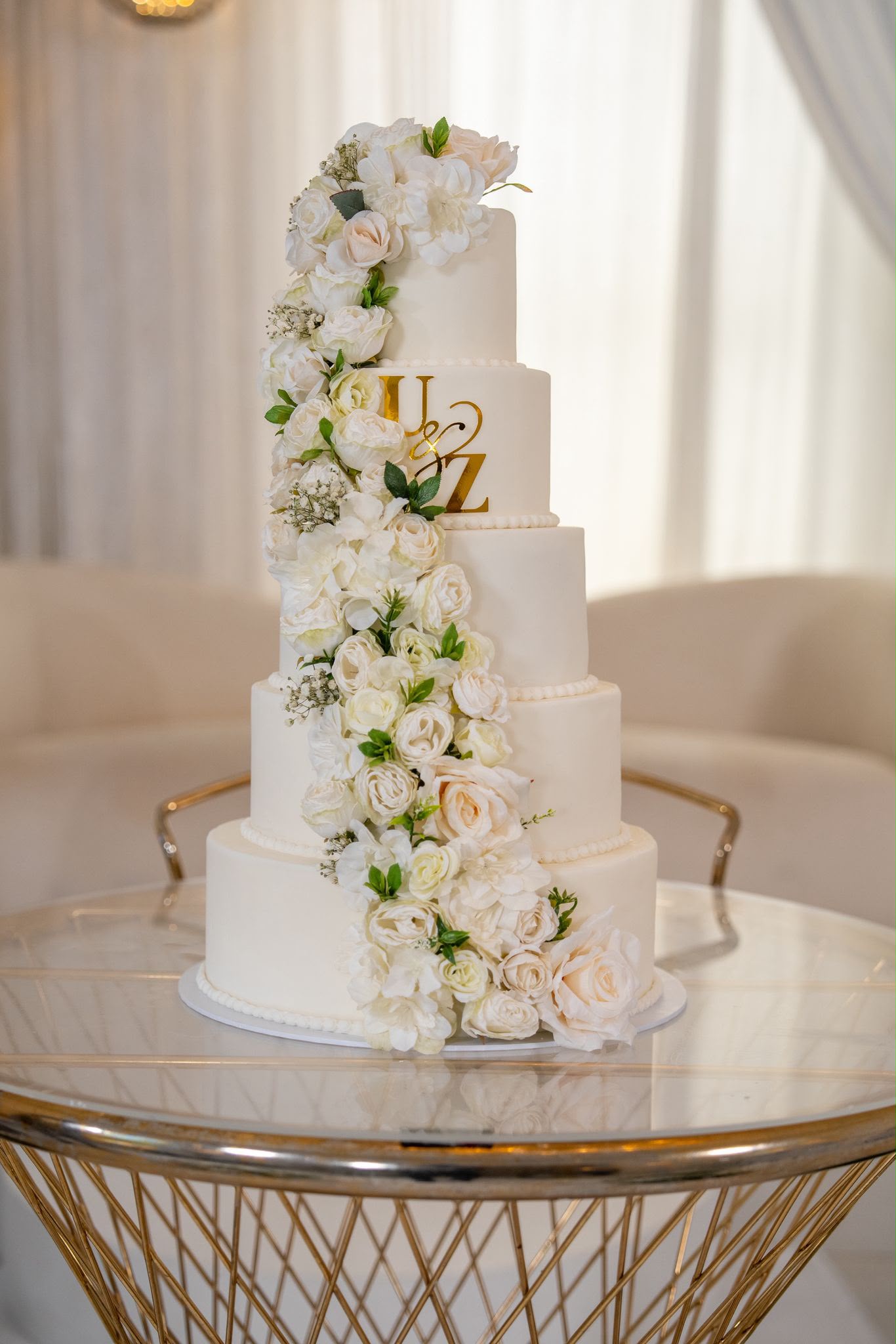 5 tier white wedding cake with cascading white roses