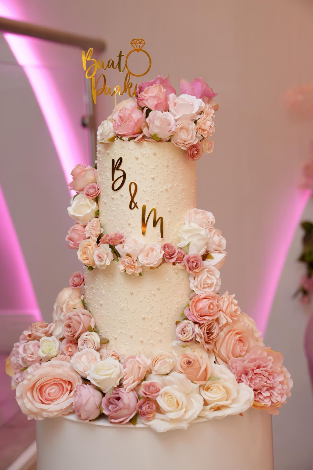 Wedding cake with fruit and red roses